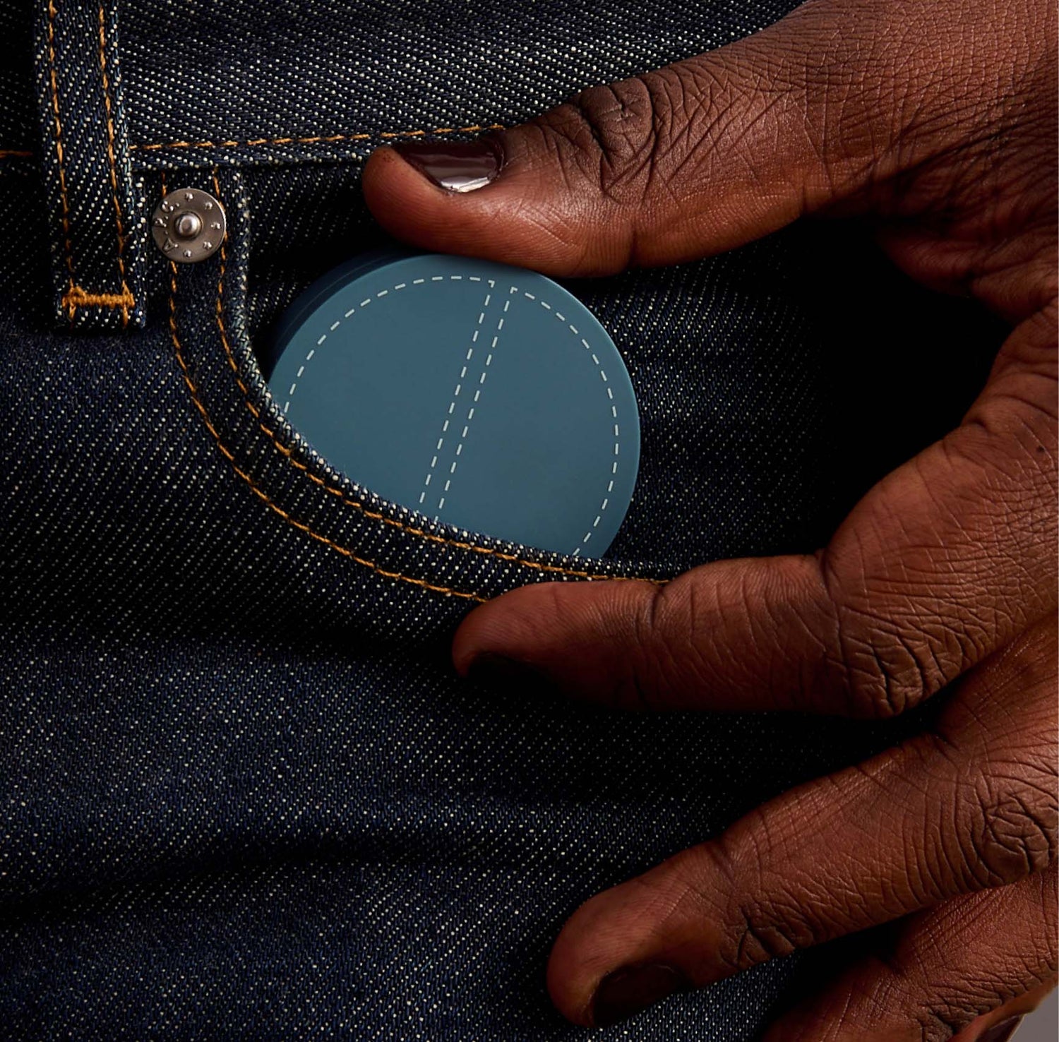 black male model putting SPATCH compact in his jeans pocket